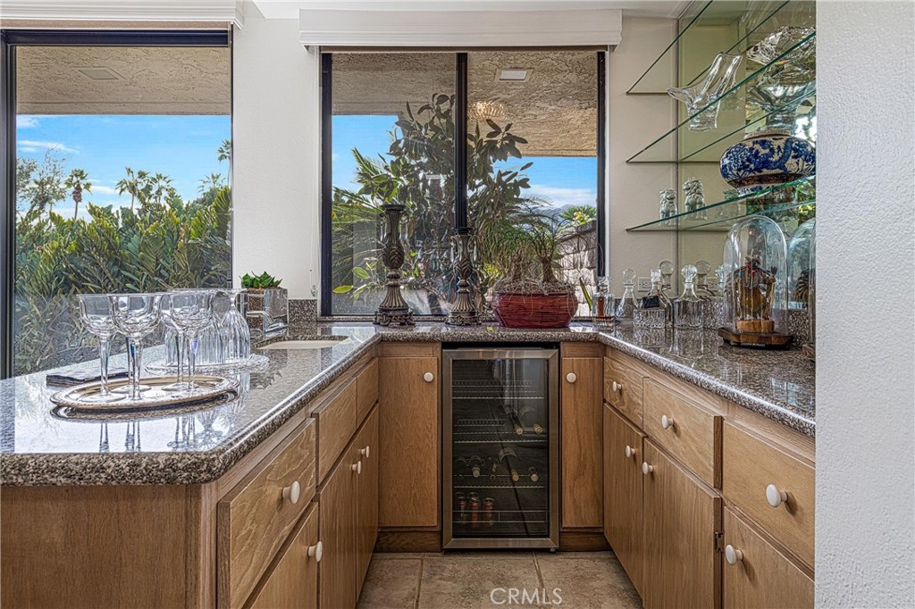 19 Cornell Drive Rancho Mirage, CA 92270 - Photo 9 of 52 a kitchen with a sink and a potted plant