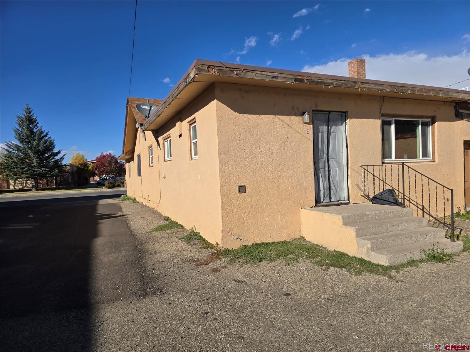 422 Fourth Street Alamosa, CO 81101 - Photo 11 of 15 a front view of a house with a yard