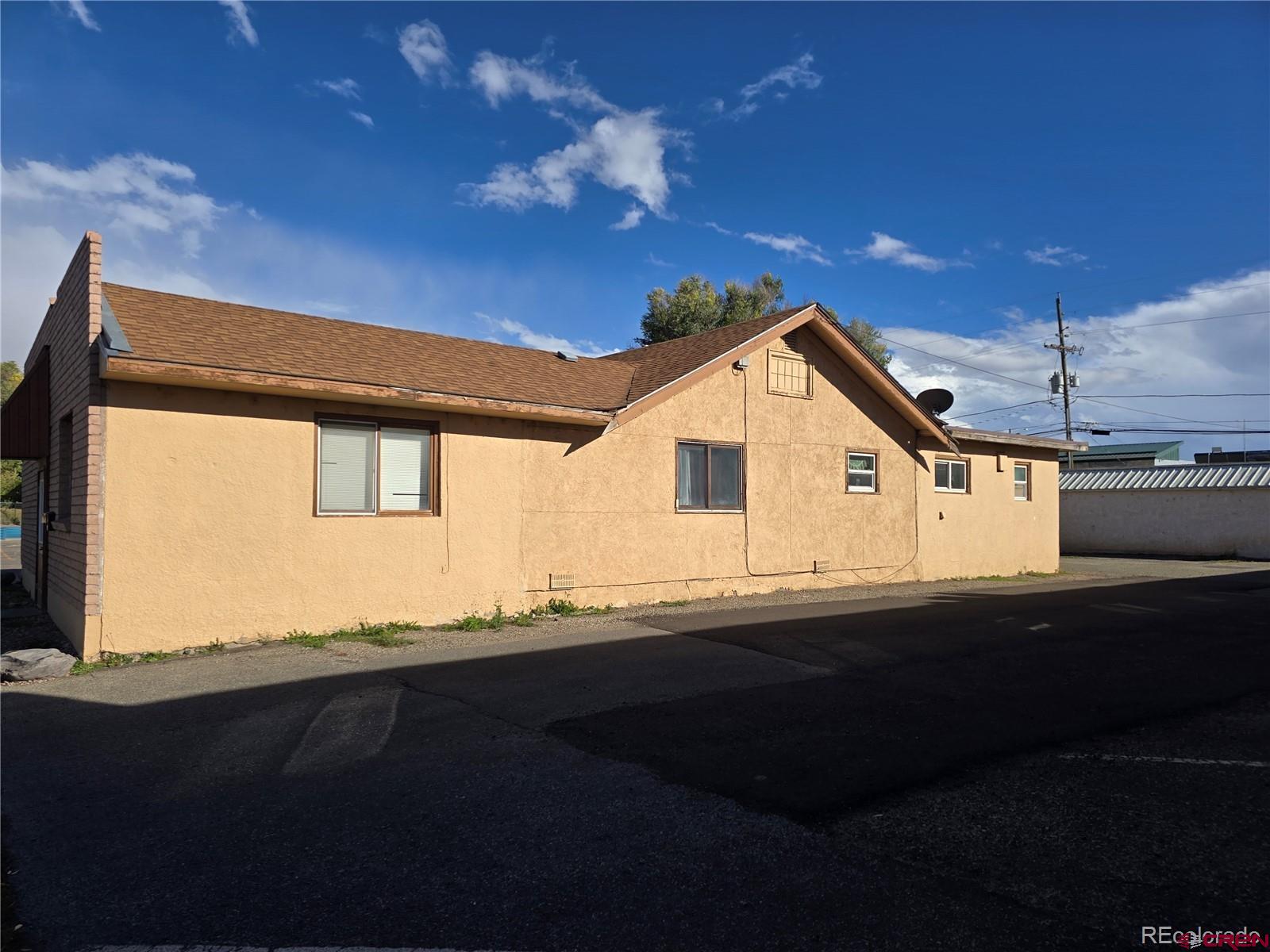 422 Fourth Street Alamosa, CO 81101 - Photo 3 of 15 a front view of a house with a yard