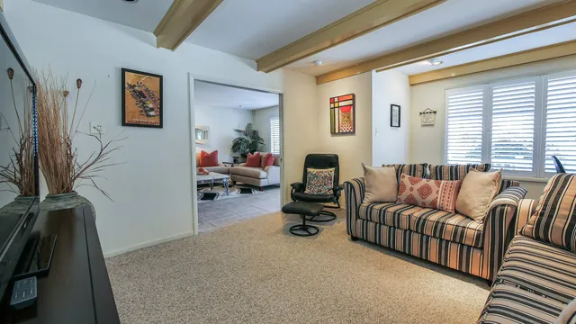 a living room with furniture a window and a flat screen tv