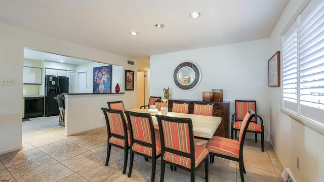 a dining room with furniture and window