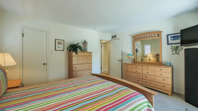 a bedroom with a bed and a dresser in it