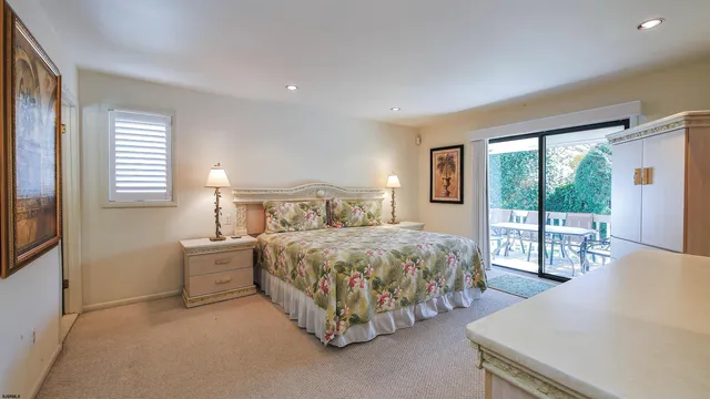 a bedroom with a bed and a night stand