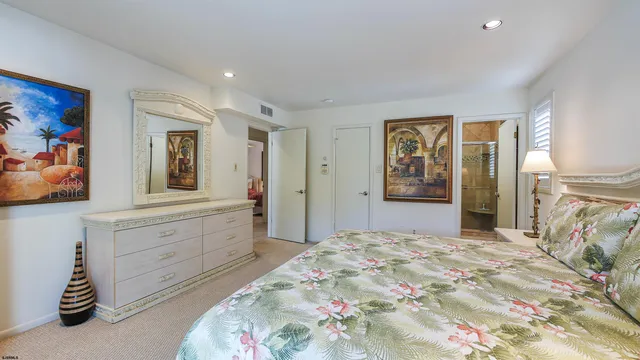 a bedroom with a large bed and a chandelier