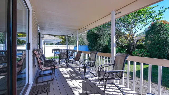 a view of a patio with a table chairs and backyard