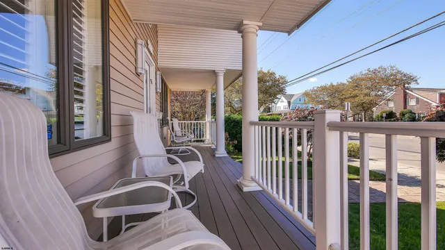 a view of balcony with wooden floor and outdoor seating