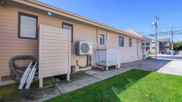 a view of a chair and table in backyard of the house