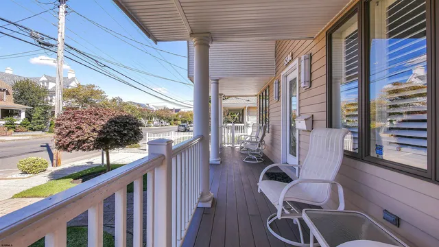a balcony view with a large window and wooden floor
