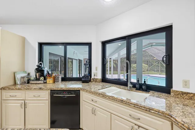 a kitchen with a dining table chairs and view living room
