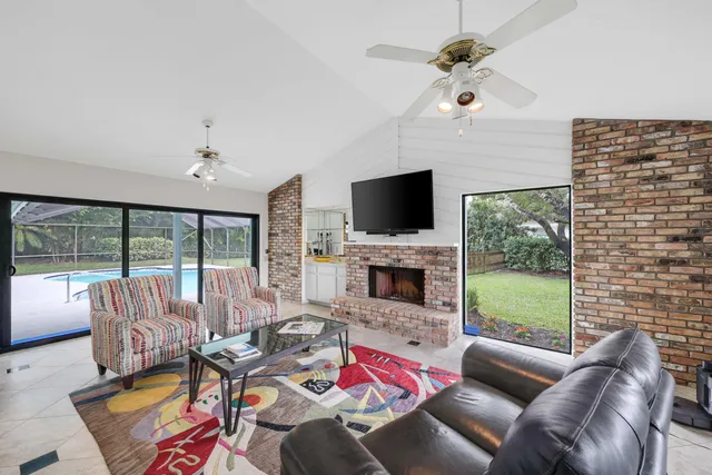 a bedroom with a bed couch and large windows