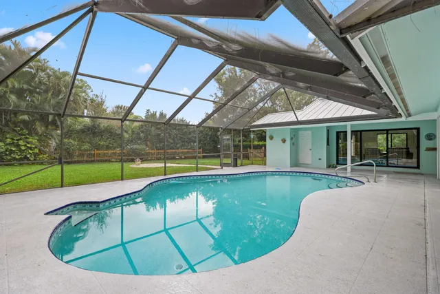 a view of swimming pool with seating area
