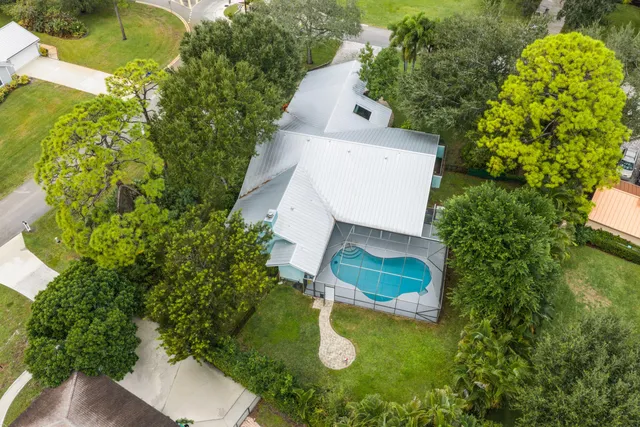 an aerial view of residential houses with outdoor space and swimming pool