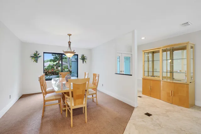 a kitchen with a sink and chairs