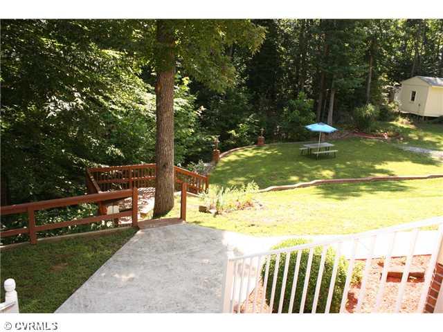 12103 Chatham Road Prince George, VA 23875 - Photo 15 of 18 Land/Lot - View from front porch - a landing to the left, a brick retaining wall enlarging the front lawn in this lush green oasis.