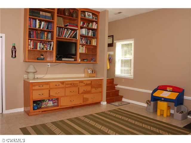 12103 Chatham Road Prince George, VA 23875 - Photo 17 of 18 Den/Family/Great Room - One of many living spaces within the home - this great room / play room has built in shelves and is oversized.