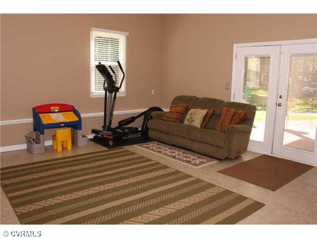 12103 Chatham Road Prince George, VA 23875 - Photo 18 of 18 Den/Family/Great Room - Another view of the great room / play room - double doors out to the side of the home.