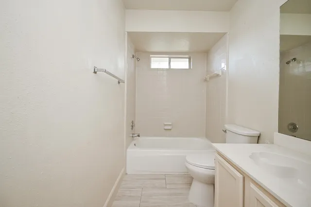 a bathroom with a toilet a sink and bathtub