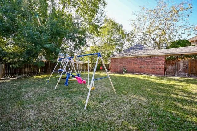 a view of a backyard with a table and chairs
