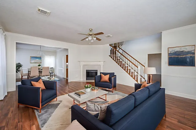 a living room with furniture or wooden floor and a chandelier