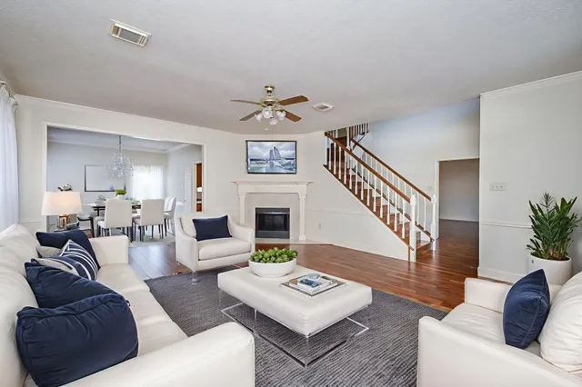 a living room with furniture a fireplace and a table