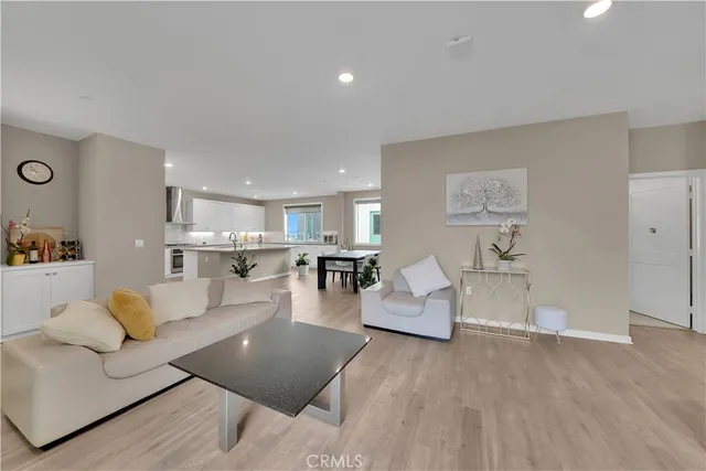 a living room with furniture and view of kitchen