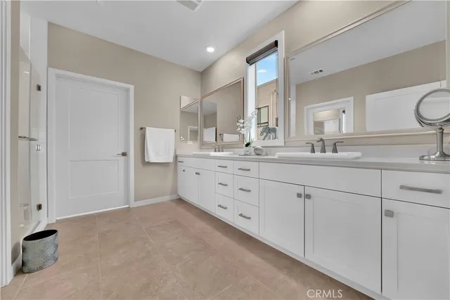 a spacious bathroom with a double vanity sink mirror and