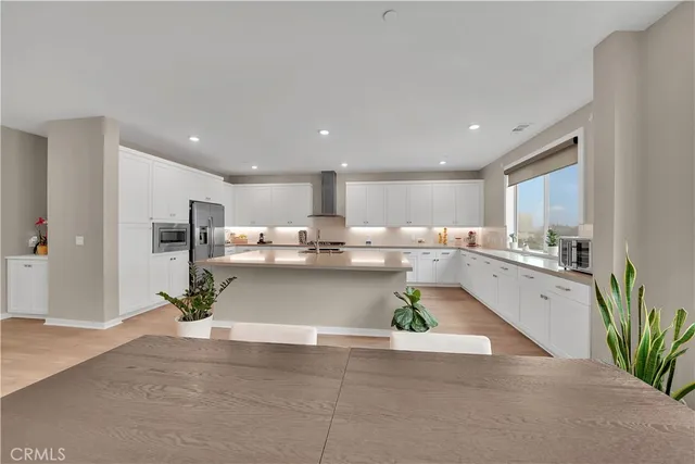 a view of kitchen with kitchen island sink refrigerator and stove