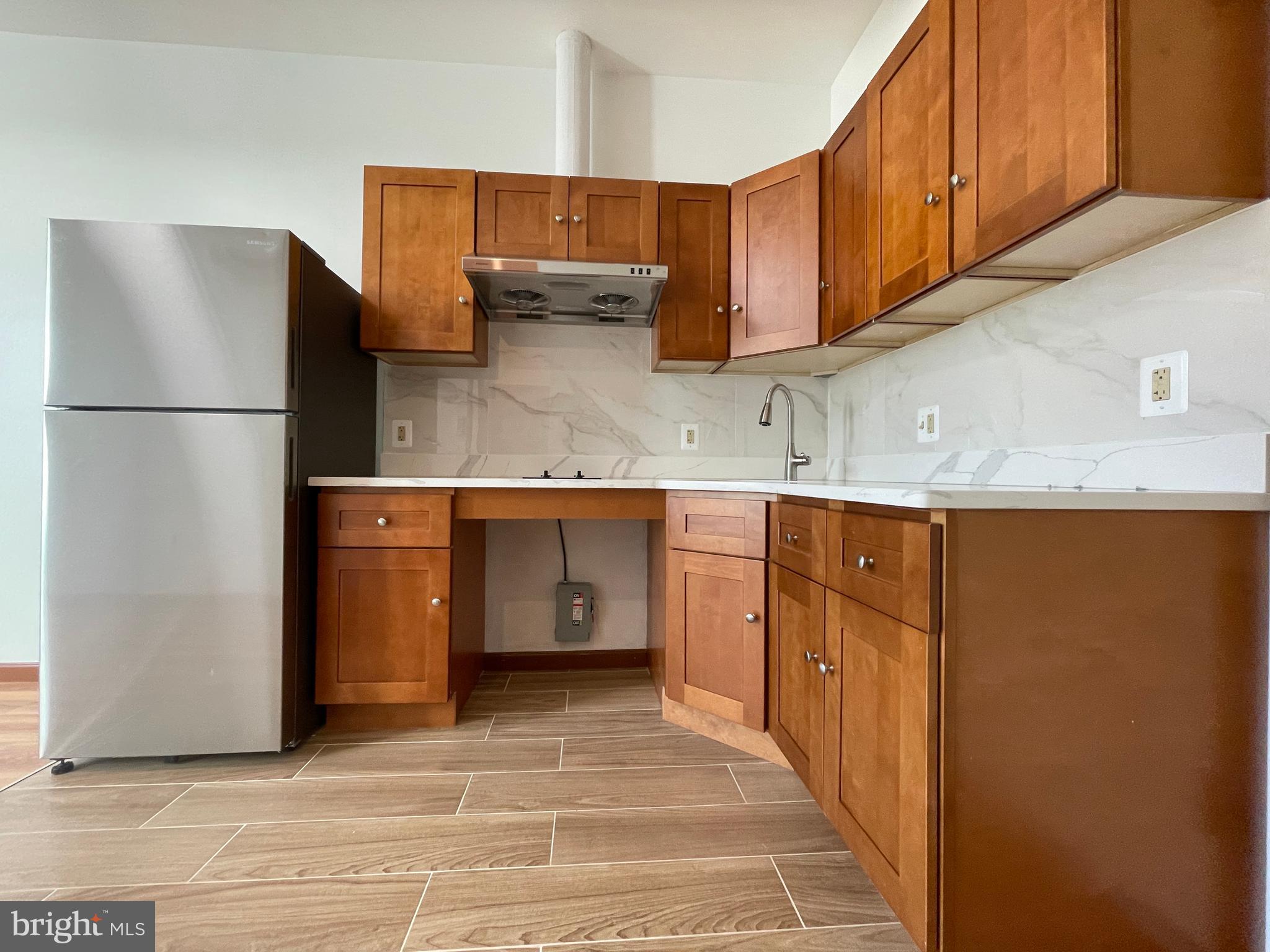 146 North 10th Street, Unit 4B Philadelphia, PA 19107 - Photo 2 of 7 a kitchen with stainless steel appliances granite countertop a refrigerator a stove and a sink