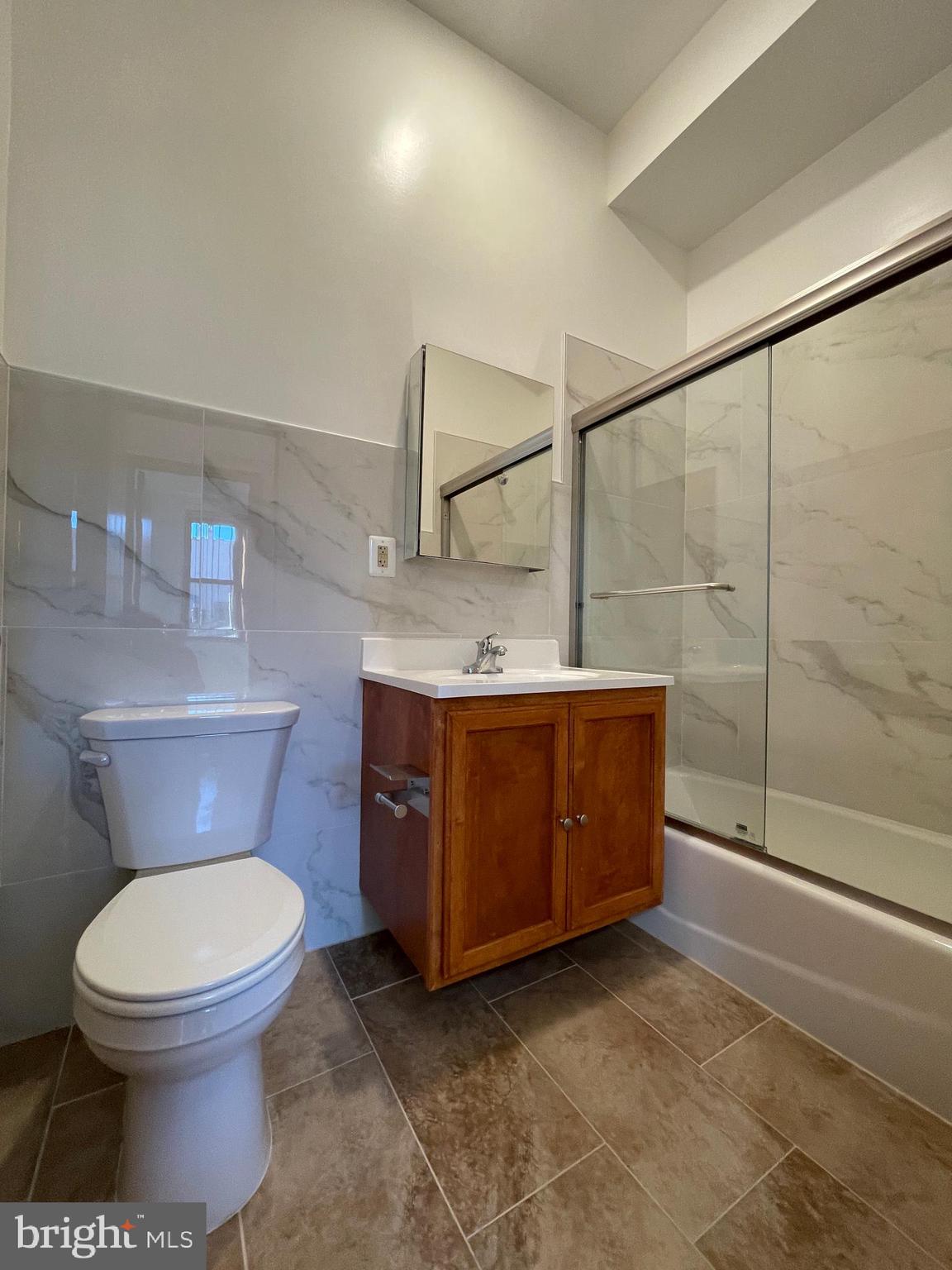 146 North 10th Street, Unit 4B Philadelphia, PA 19107 - Photo 6 of 7 a bathroom with a toilet a sink and mirror