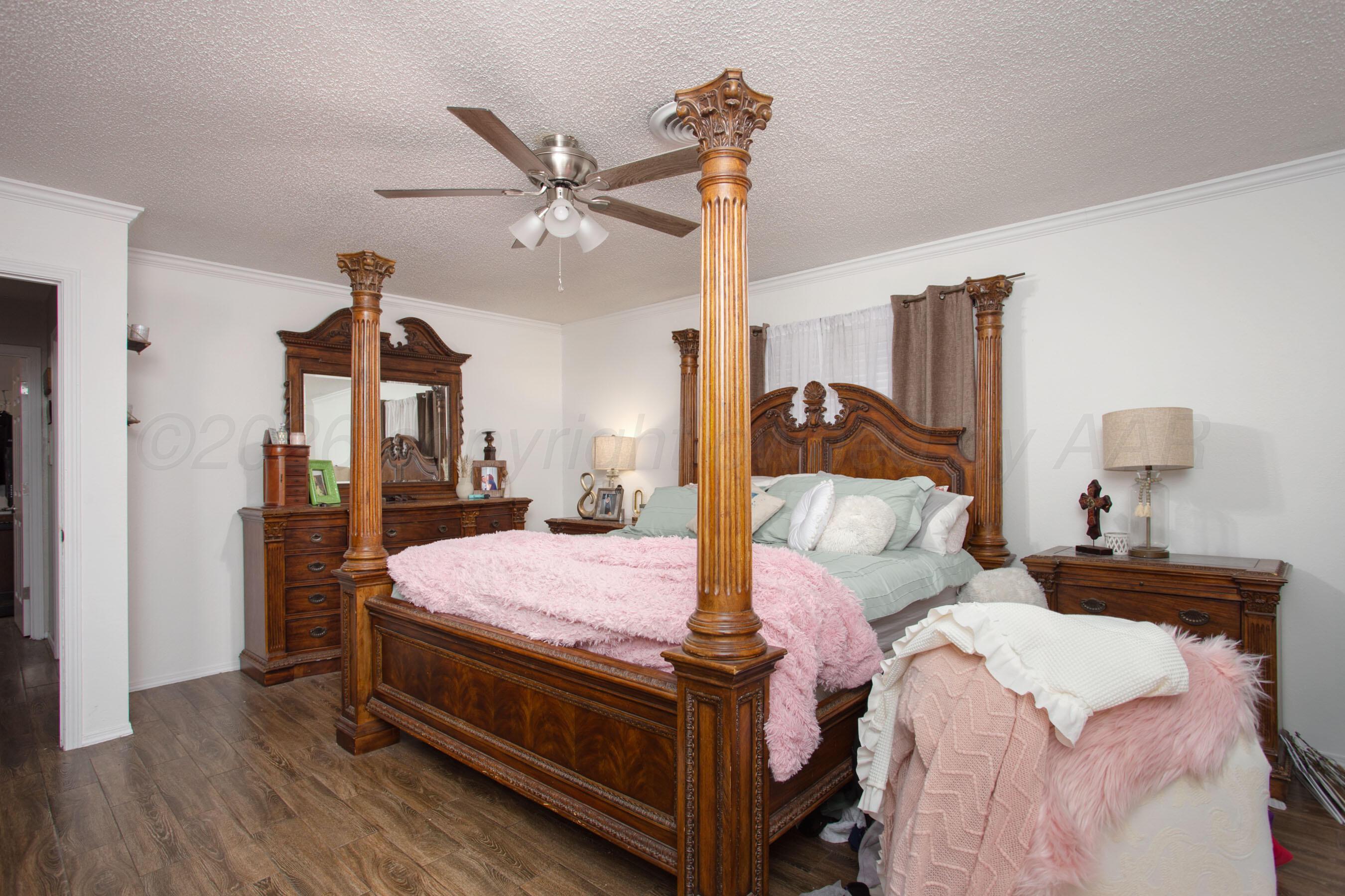2907 Mable Drive Canyon, TX 79015 - Photo 16 of 23 a bedroom with a bed and wooden floor
