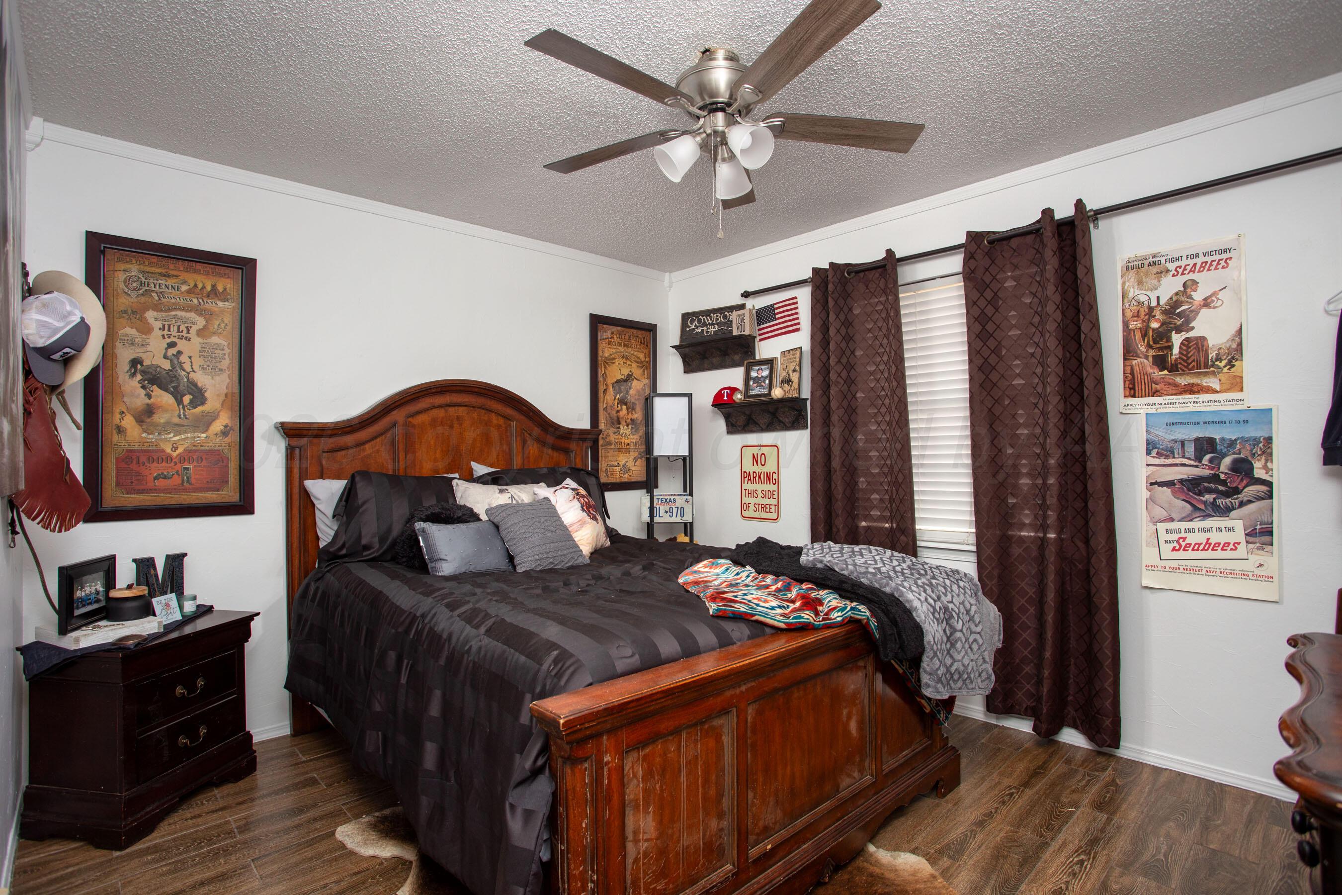 2907 Mable Drive Canyon, TX 79015 - Photo 20 of 23 a bedroom with a large bed and a chandelier