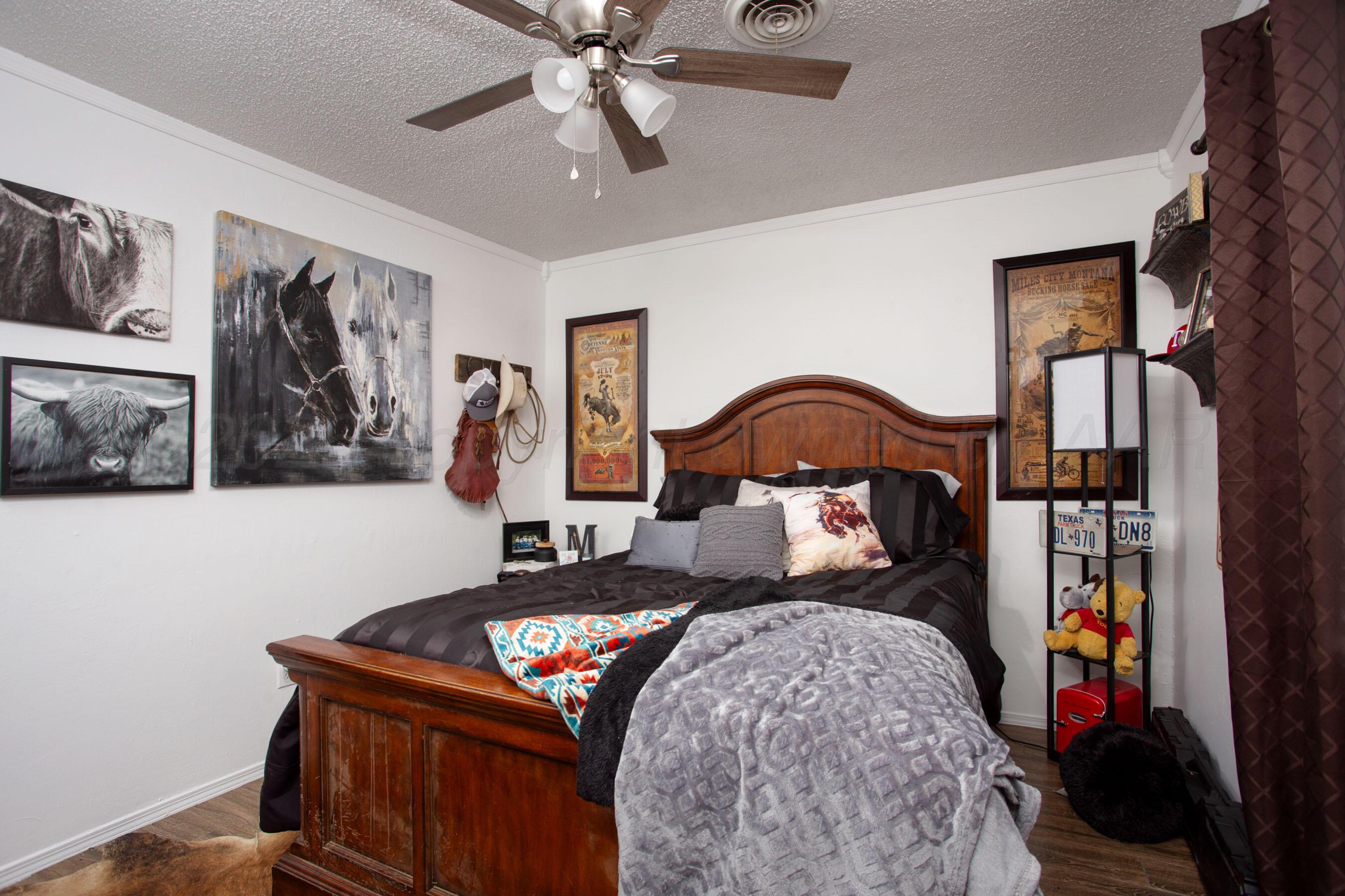 2907 Mable Drive Canyon, TX 79015 - Photo 21 of 23 a bedroom with a bed and a painting on the wall