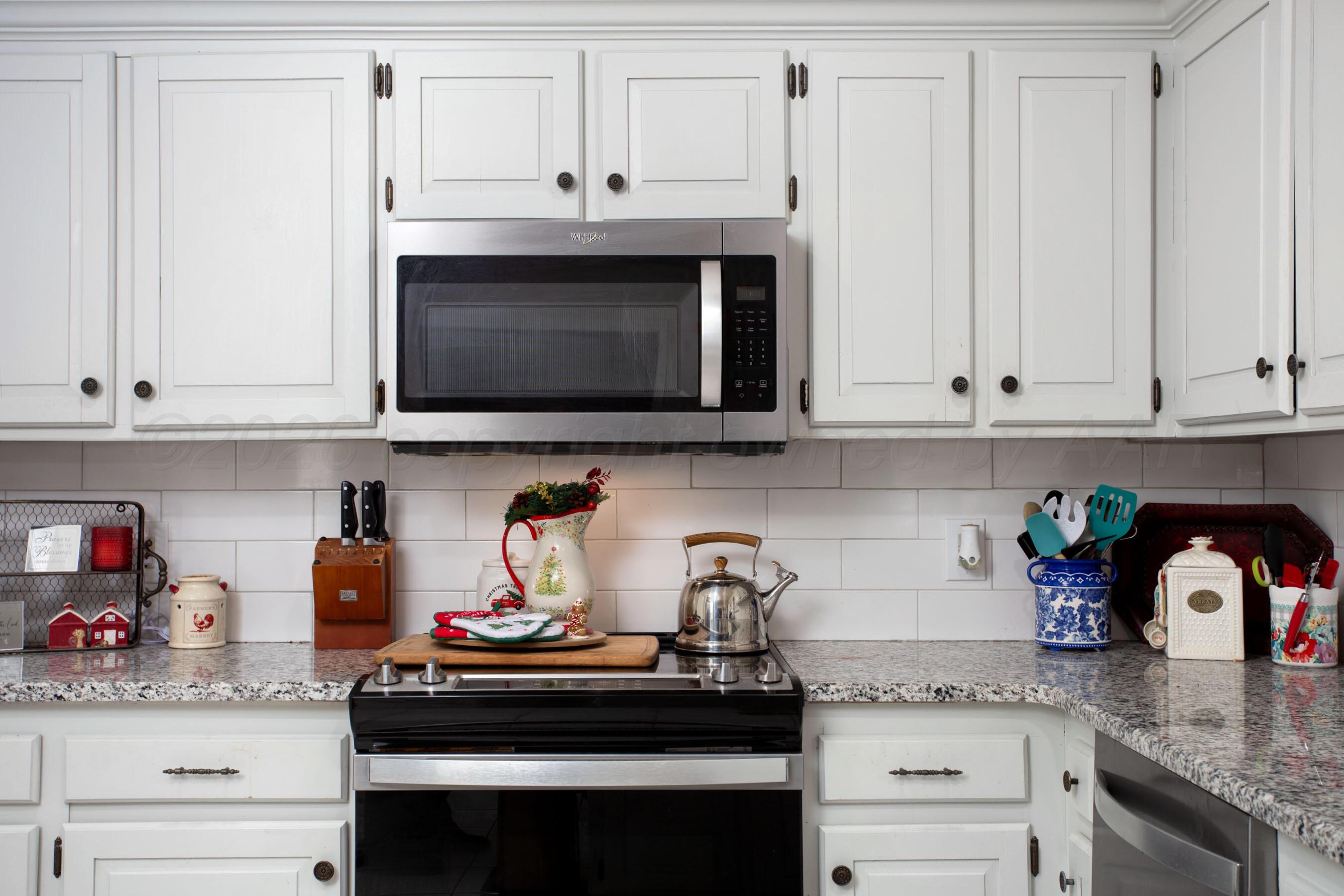 2907 Mable Drive Canyon, TX 79015 - Photo 5 of 23 a kitchen with stainless steel appliances granite countertop white cabinets and a stove