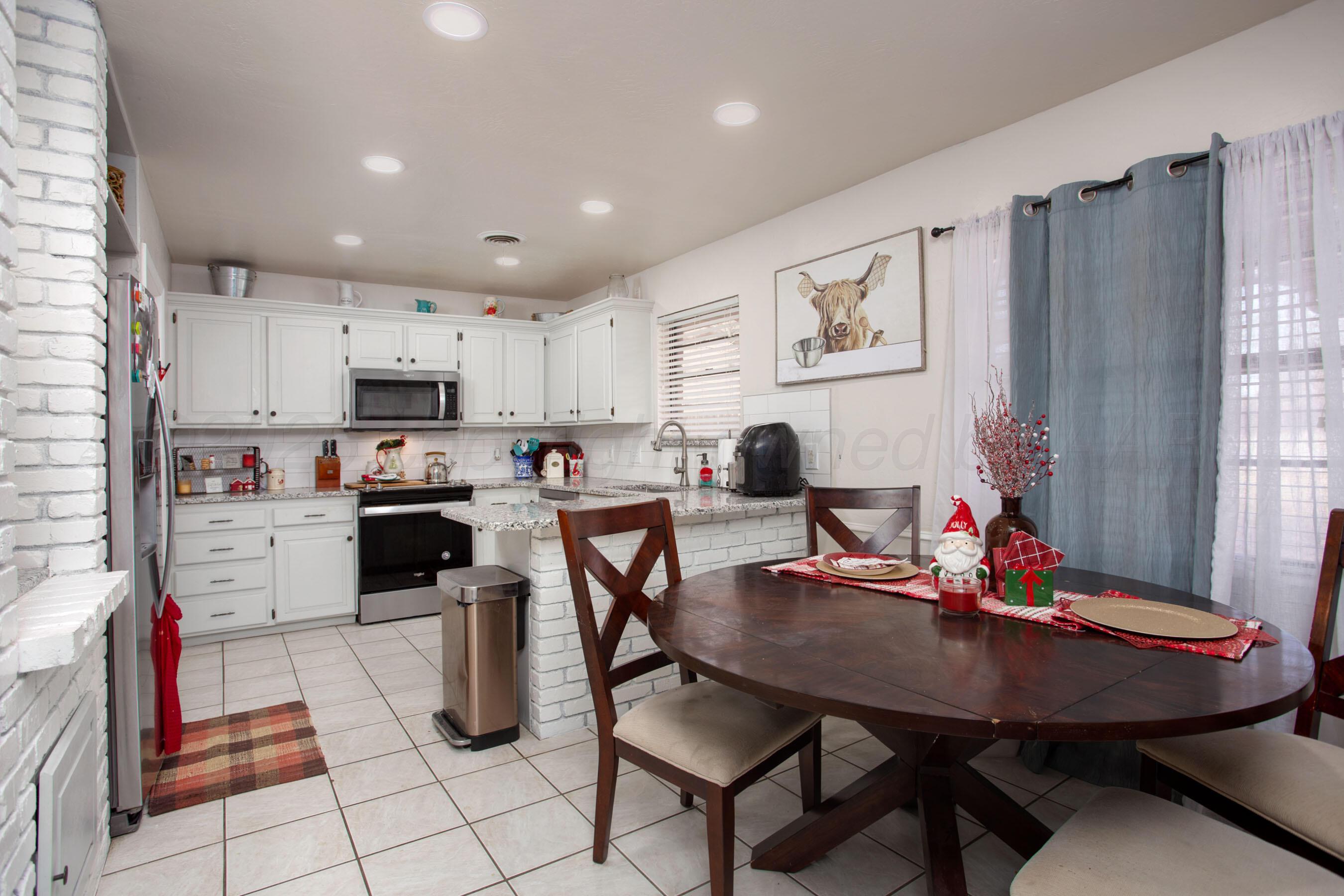 2907 Mable Drive Canyon, TX 79015 - Photo 7 of 23 a open kitchen with stainless steel appliances kitchen island granite countertop a table chairs and a refrigerator