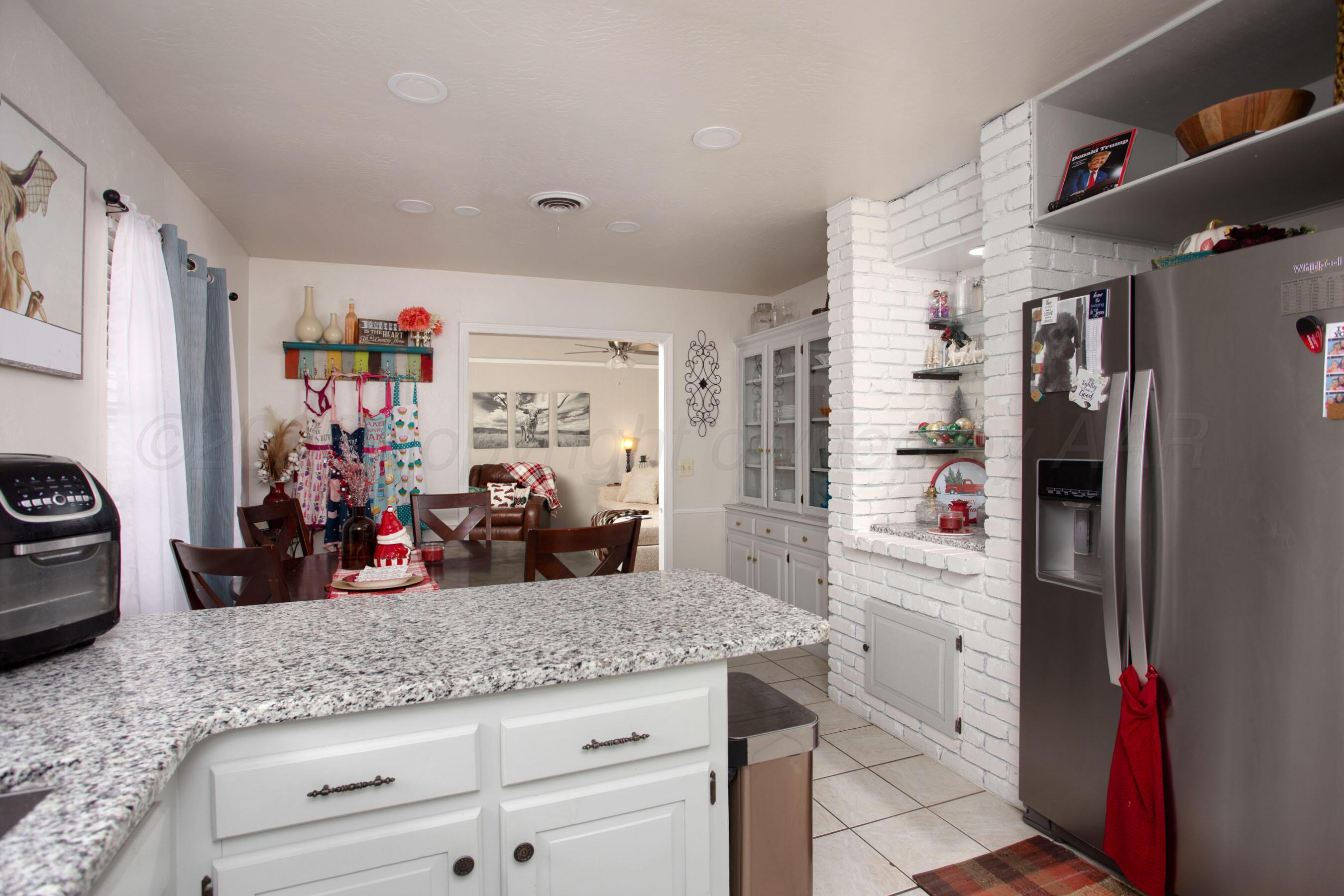 2907 Mable Drive Canyon, TX 79015 - Photo 9 of 23 a kitchen with granite countertop a refrigerator and a sink