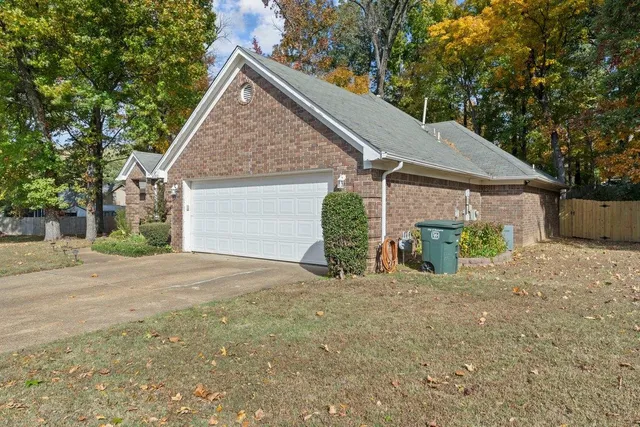 a view of a house with a yard and garage