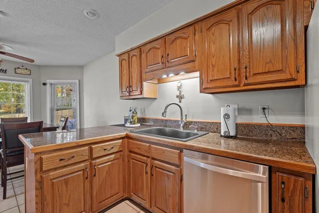 a kitchen with stainless steel appliances granite countertop a sink stove and cabinets