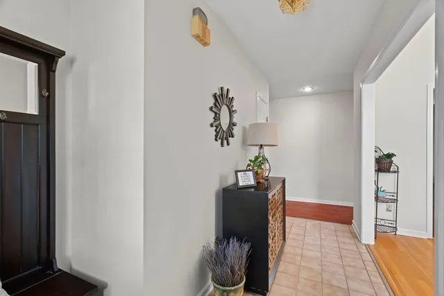 a view of entryway and hall with wooden floor