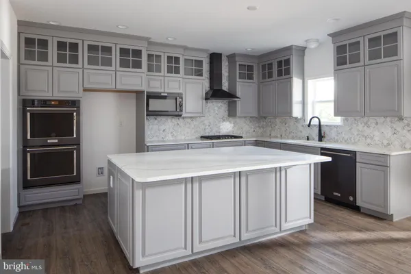 a kitchen with a stove a sink and a microwave
