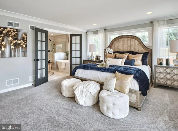 a bedroom with bed and a large window
