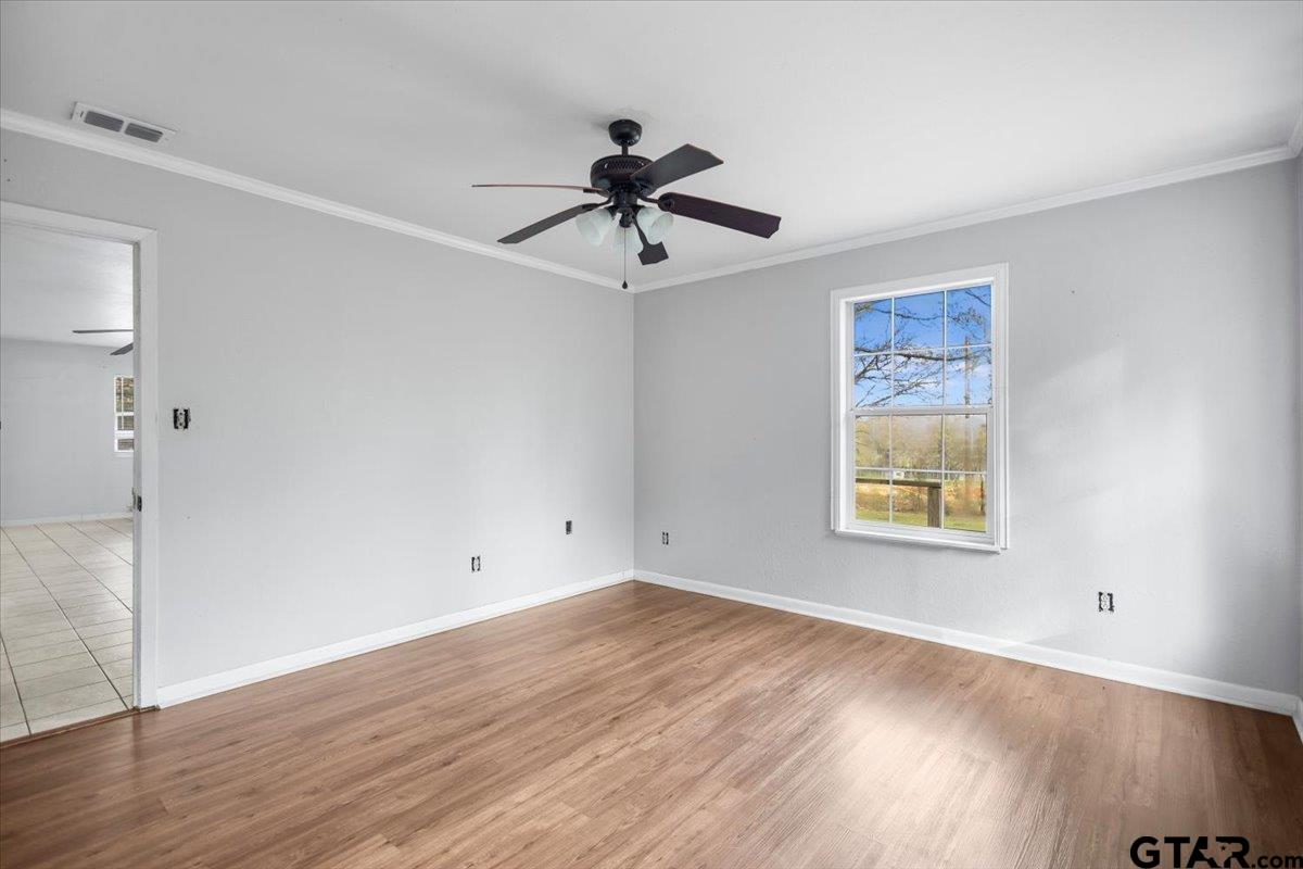 13546 FM 3271 Tyler, TX 75704 - Photo 13 of 20 a view of a room with wooden floor and ceiling fan