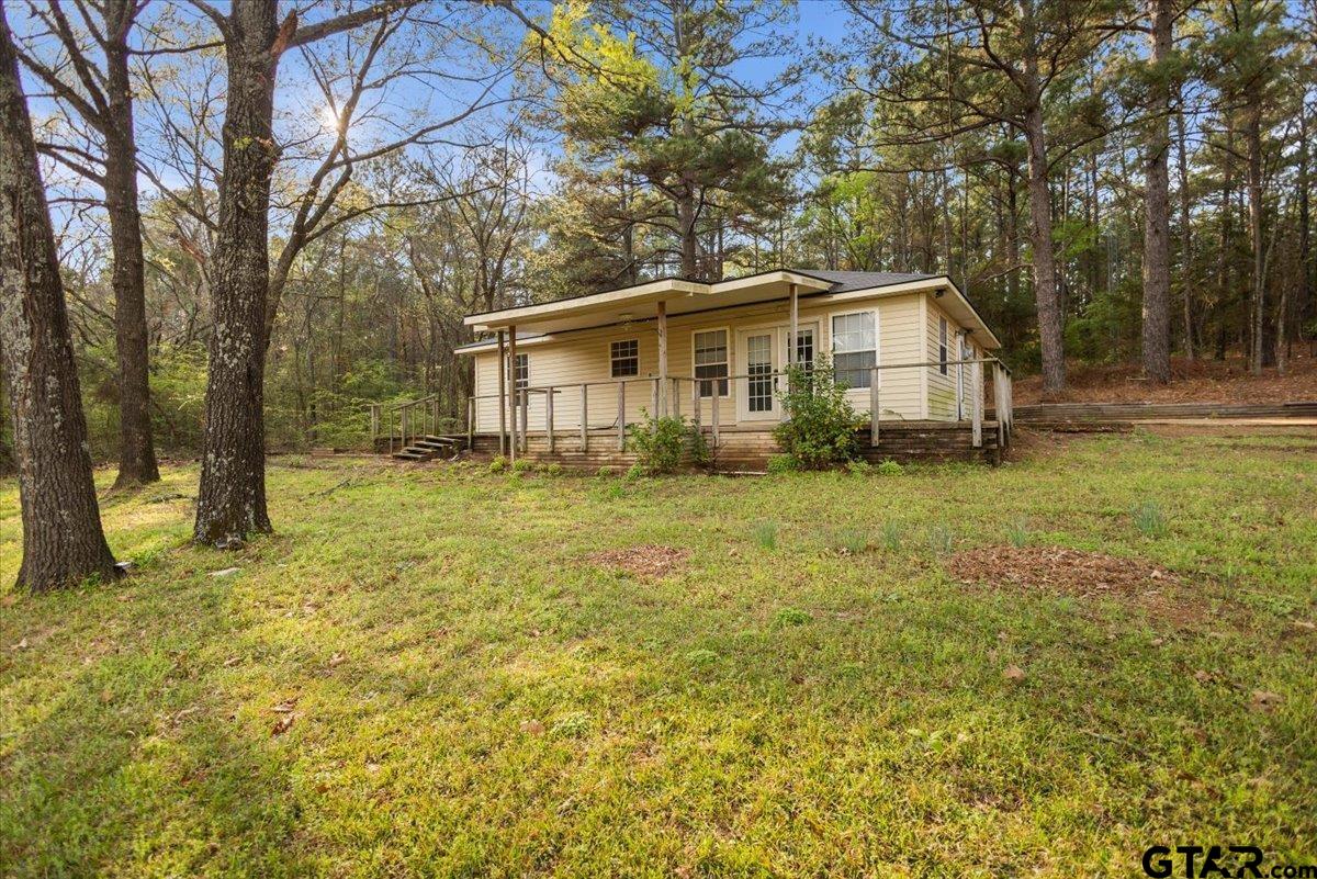 13546 FM 3271 Tyler, TX 75704 - Photo 2 of 20 a view of a house with a big yard and large trees