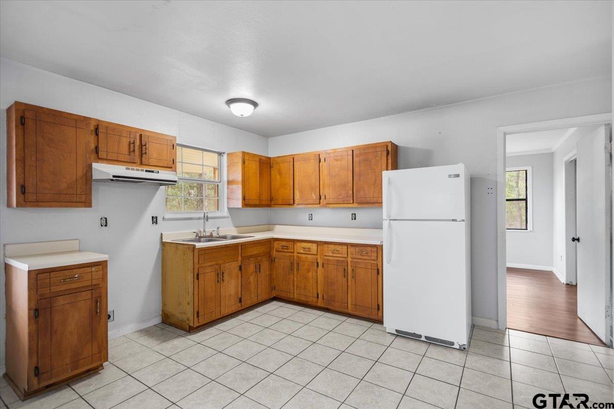 13546 FM 3271 Tyler, TX 75704 - Photo 8 of 20 a kitchen with a refrigerator a stove top oven and cabinets