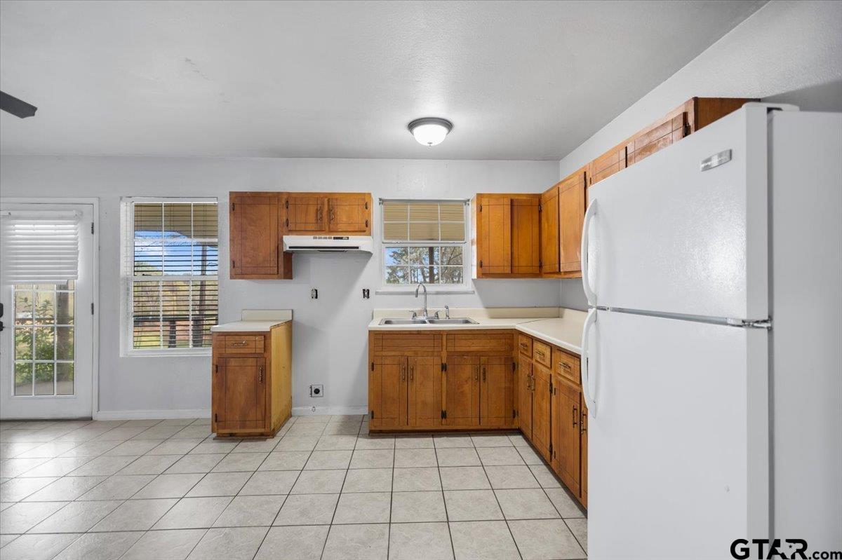 13546 FM 3271 Tyler, TX 75704 - Photo 9 of 20 a kitchen with granite countertop a refrigerator and a sink