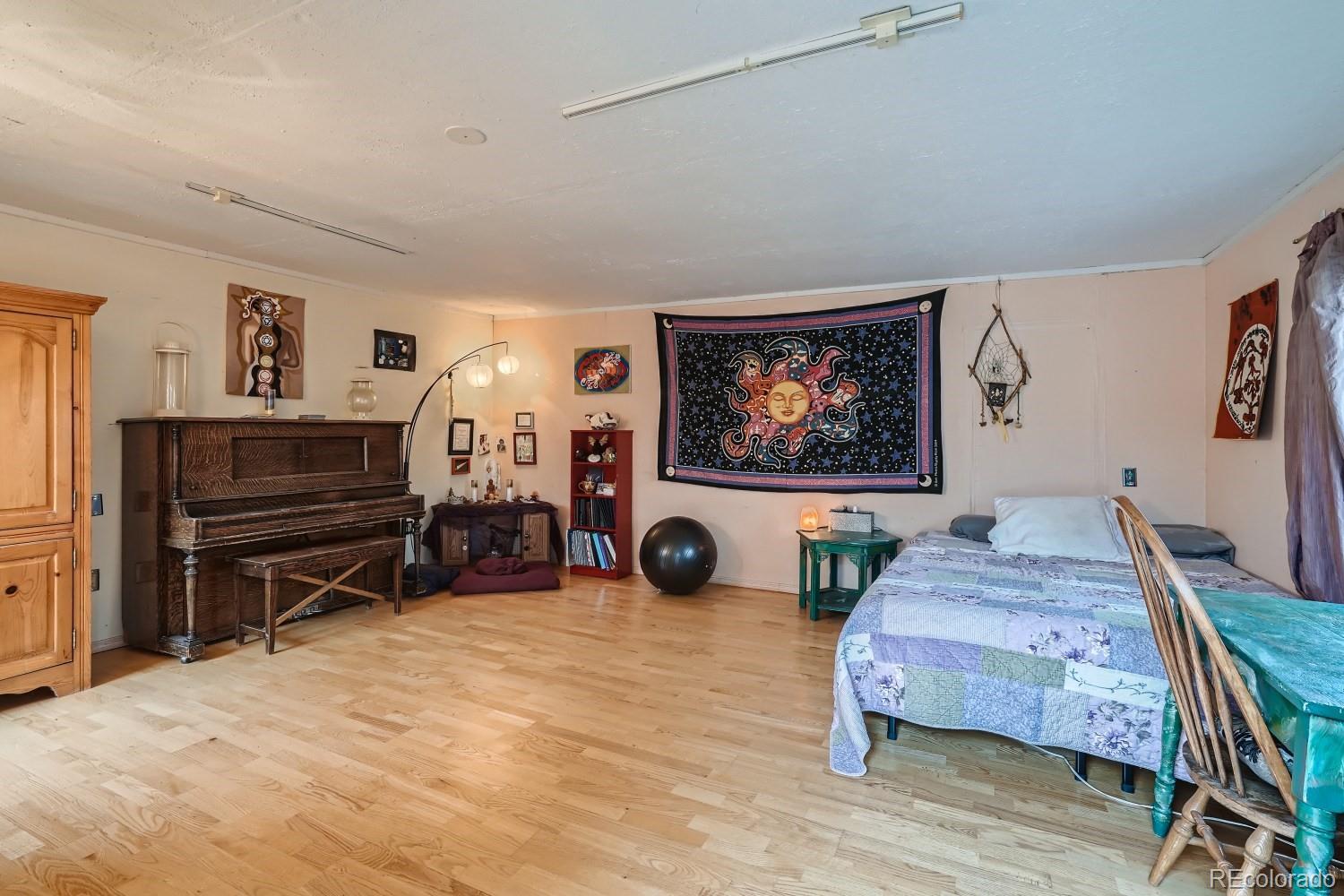 507 West Baseline Road Lafayette, CO 80026 - Photo 20 of 28 a bedroom with furniture and a bed