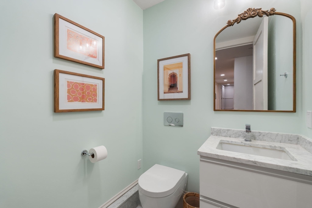 1762 Beacon Street, Unit 1 Brookline, MA 02445 - Photo 11 of 17 a bathroom with a toilet a sink and mirror