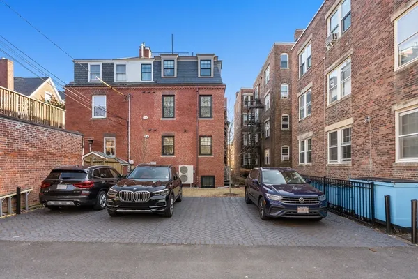 a car parked in front of a brick building