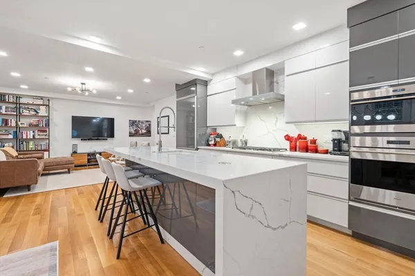 a kitchen with stainless steel appliances granite countertop a sink and cabinets