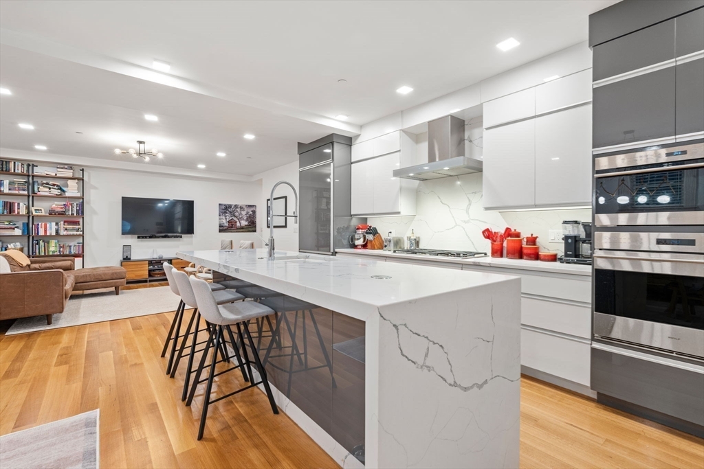 1762 Beacon Street, Unit 1 Brookline, MA 02445 - Photo 2 of 17 a kitchen with stainless steel appliances granite countertop a sink and cabinets