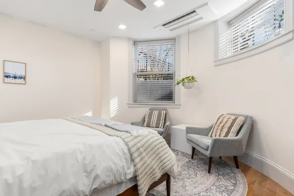 a bedroom with a bed and a chair